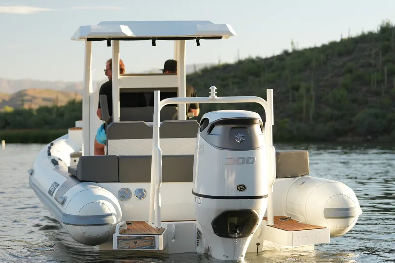 Slide: The Image of 2027 Tide Craft 26 Capri boat with Suzuki 300 engine on a serene lake. - 7