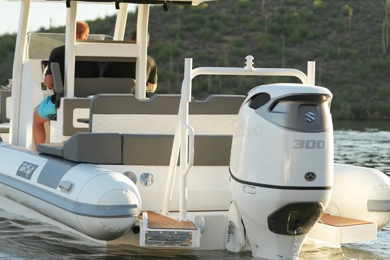 Slide: The Image of 2027 Tide Craft 26 Capri boat with Suzuki 300 engine on a serene lake. - 8