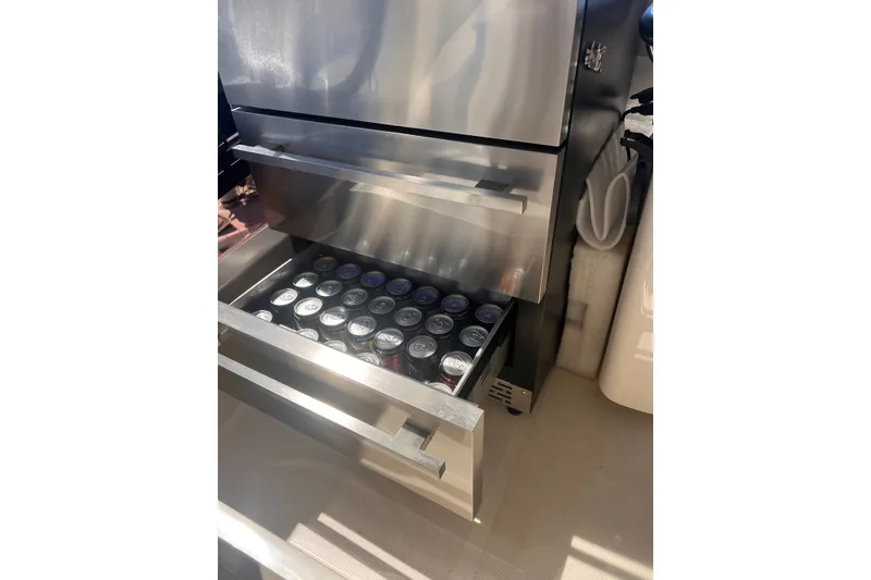 Slide: The Image of Stainless steel drawer fridge on 2018 Aquila 44 Yacht, stocked with beverage cans. - 19