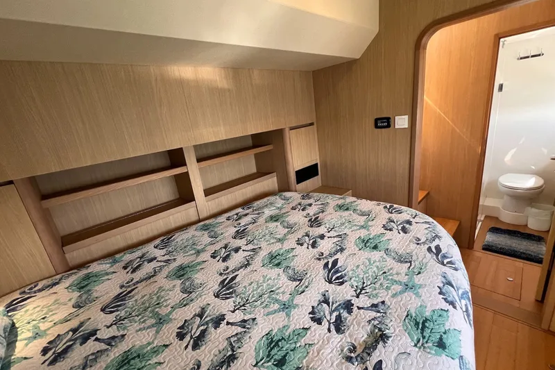 Slide: The Image of Cozy bedroom in 2018 Aquila 44 Yacht with floral bedding and ensuite bathroom. - 31