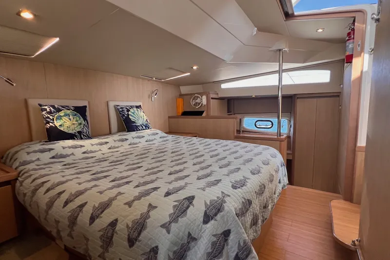 Slide: The Image of Luxurious bedroom interior of 2018 Aquila 44 Yacht with fish-patterned bedding. - 56