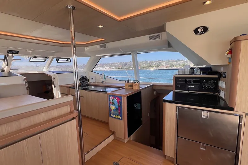 Slide: The Image of Interior of 2018 Aquila 44 Yacht with modern kitchen and panoramic windows. - 44
