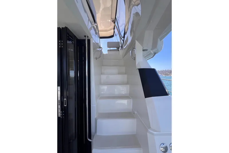 Slide: The Image of Staircase on 2018 Aquila 44 Yacht, leading to upper deck with ocean view. - 13