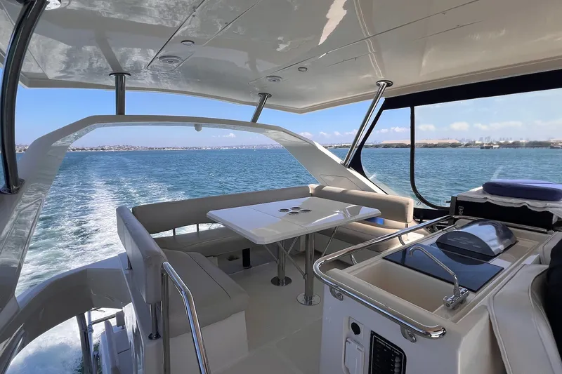 Slide: The Image of Luxurious 2018 Aquila 44 Yacht interior with ocean view and sleek seating area. - 19