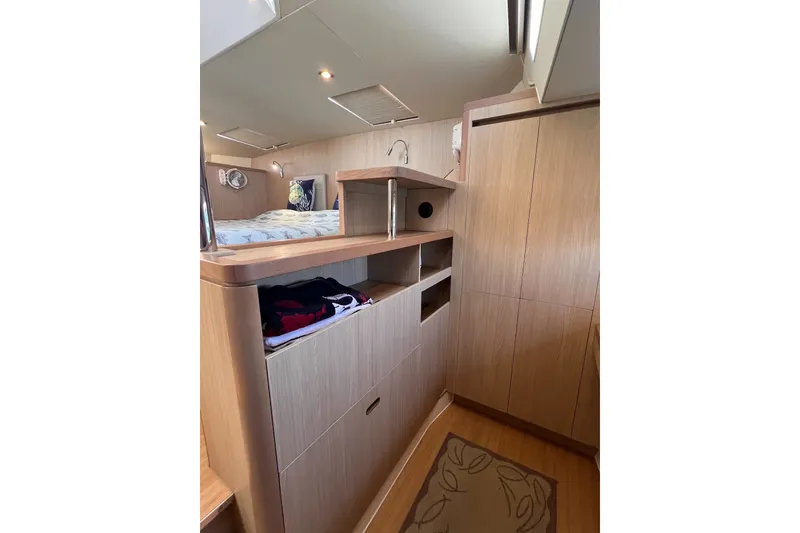 Slide: The Image of Interior cabin of 2018 Aquila 44 Yacht with wooden storage and bed. - 58