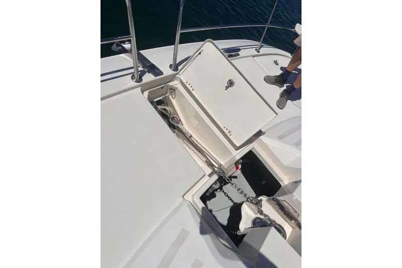 Slide: The Image of Open anchor compartment on 2018 Aquila 44 Yacht deck with visible chain and railing. - 66