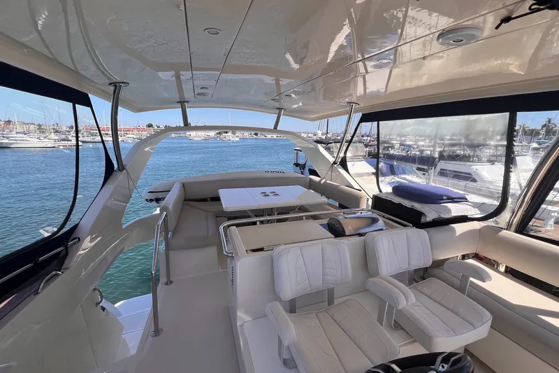 Slide: The Image of Luxurious 2018 Aquila 44 Yacht interior with elegant seating and scenic marina view. - 16