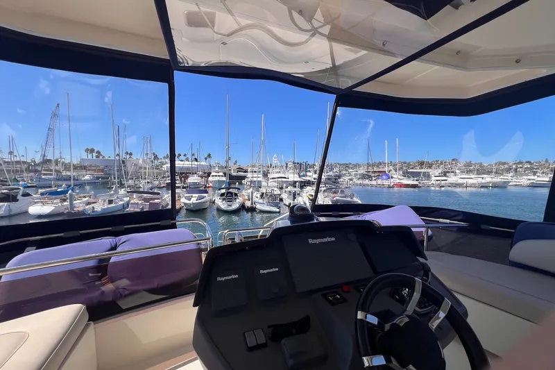 Slide: The Image of Cockpit view from 2018 Aquila 44 Yacht overlooking marina with numerous boats docked. - 12