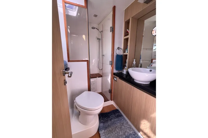 Slide: The Image of Modern bathroom on 2018 Aquila 44 Yacht with shower, toilet, and sink. - 55
