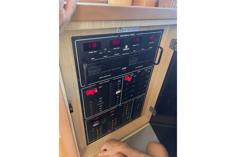Slide: The Image of Electrical control panel on a 2018 Aquila 44 Yacht, displaying voltage readings. - 34