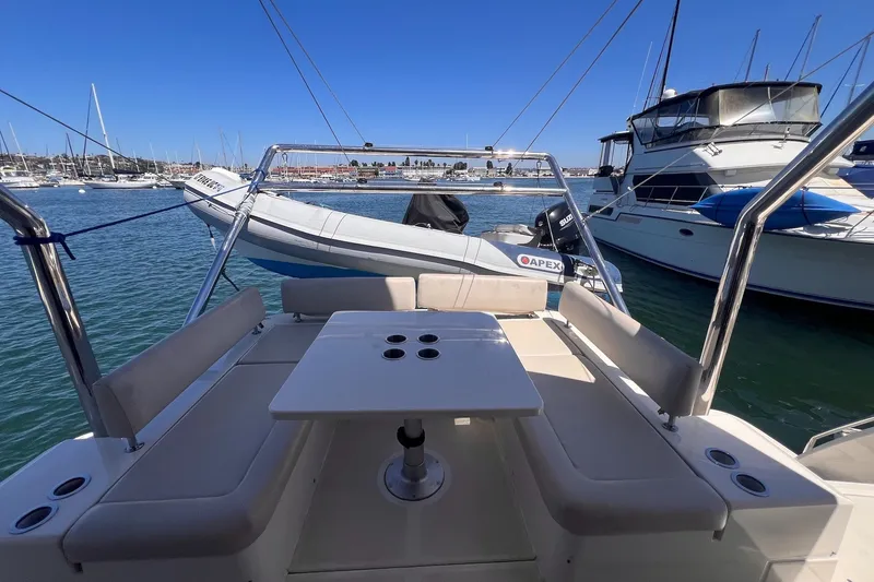 Slide: The Image of 2018 Aquila 44 Yacht with seating area and table, docked in a marina. - 21