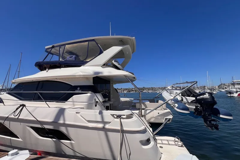 Slide: The Image of 2018 Aquila 44 Yacht docked in a marina under clear blue skies. - 4