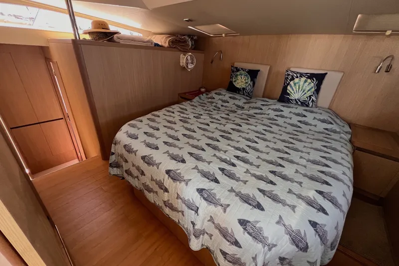 Slide: The Image of Cozy bedroom in 2018 Aquila 44 Yacht with fish-patterned bedding and decorative pillows. - 46