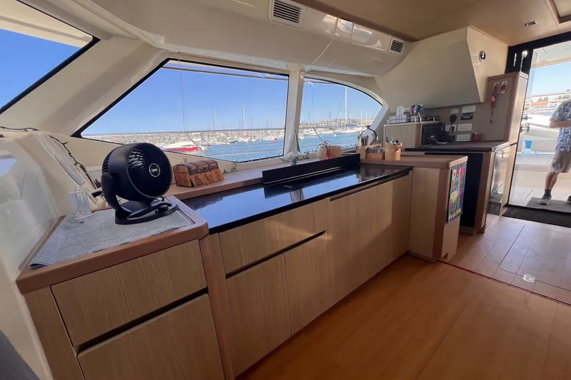 Slide: The Image of Interior of 2018 Aquila 44 Yacht with modern kitchen and large windows. - 42