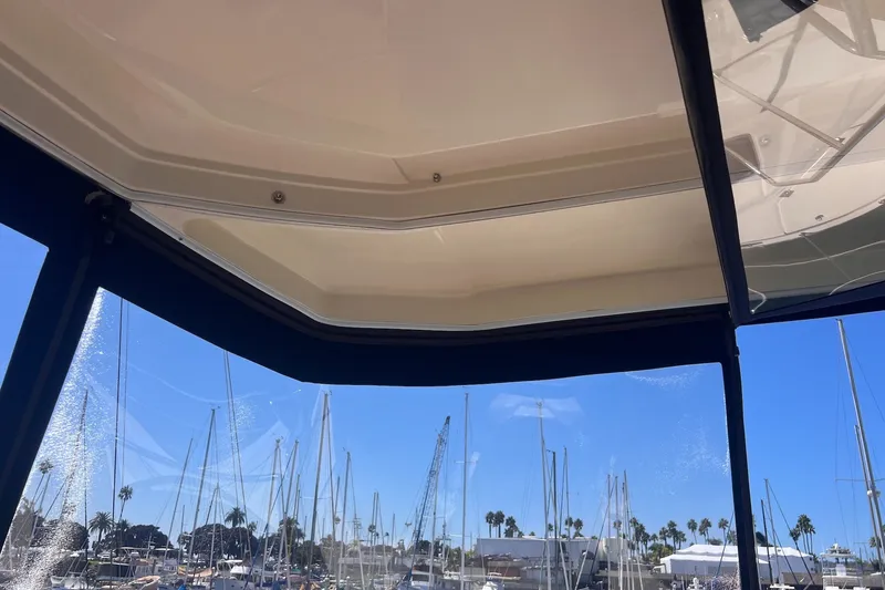 Slide: The Image of View from inside a 2018 Aquila 44 Yacht, overlooking a marina with clear blue skies. - 13