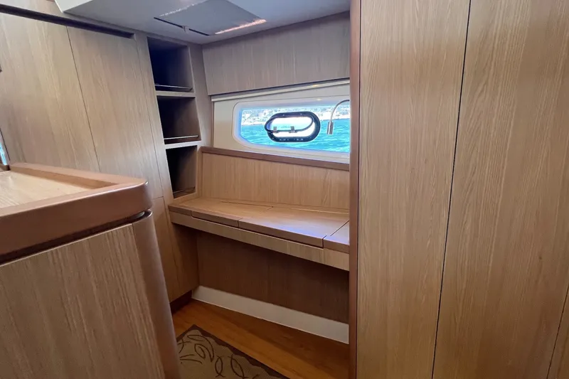 Slide: The Image of Interior of 2018 Aquila 44 Yacht with wooden cabinetry and ocean view window. - 57