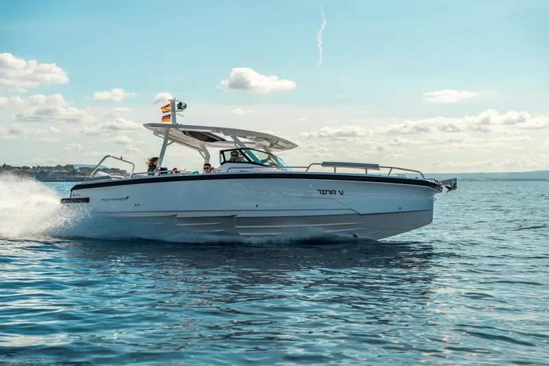 The Image of 2027 Axopar 29 Sun-Top cruising on open water under a clear sky. - 4