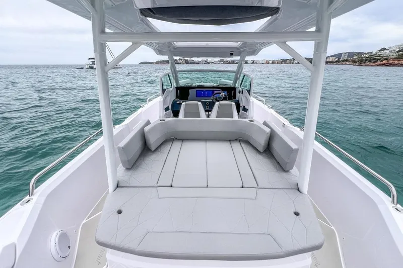Slide: The Image of 2027 Axopar 29 Sun-Top boat with spacious seating on open water. - 9