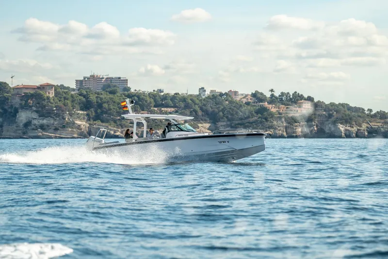Slide: The Image of 2027 Axopar 29 Sun-Top cruising on blue ocean near scenic coastline. - 3