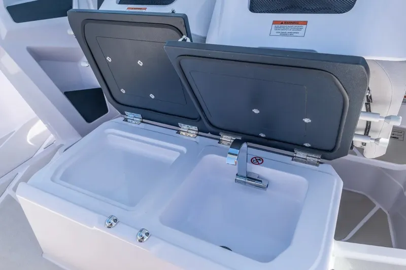 Slide: The Image of 2027 Axopar 29 Sun-Top boat sink with dual compartments and sleek faucet design. - 14