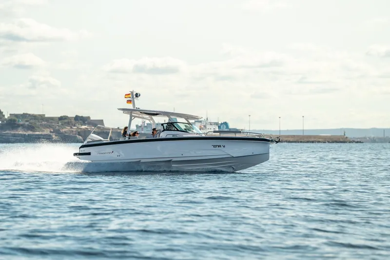 Slide: The Image of 2027 Axopar 29 Sun-Top cruising on open water, showcasing sleek design and performance. - 5