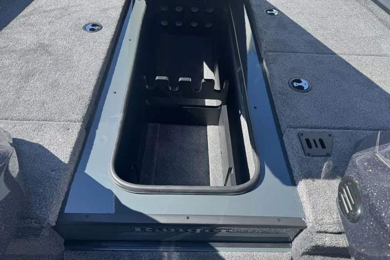 Slide: The Image of Ranger RT198P 2027 boat interior with open storage compartment and carpeted flooring. - 14