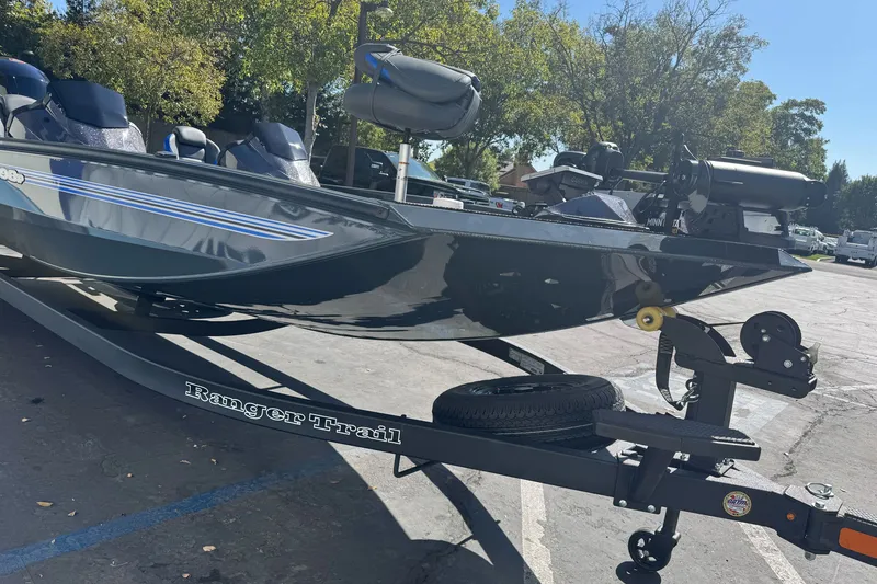 Slide: The Image of 2027 Ranger RT198P boat on trailer in parking lot, surrounded by trees. - 5