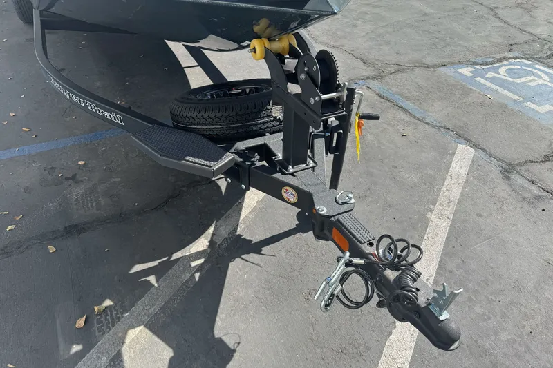 Slide: The Image of Trailer hitch of a 2027 Ranger RT198P boat in a parking lot. - 4