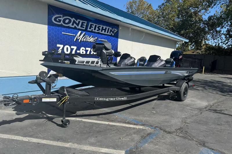 Slide: The Image of 2027 Ranger RT198P fishing boat on trailer at dealership, "Gone Fishin' Marine" sign visible. - 3