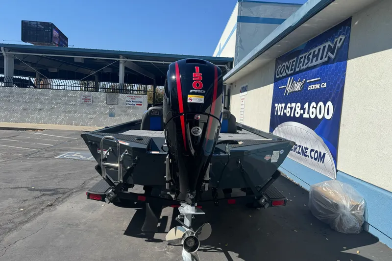 Slide: The Image of 2027 Ranger RT198P boat with 150 horsepower engine parked outside a marine shop. - 7