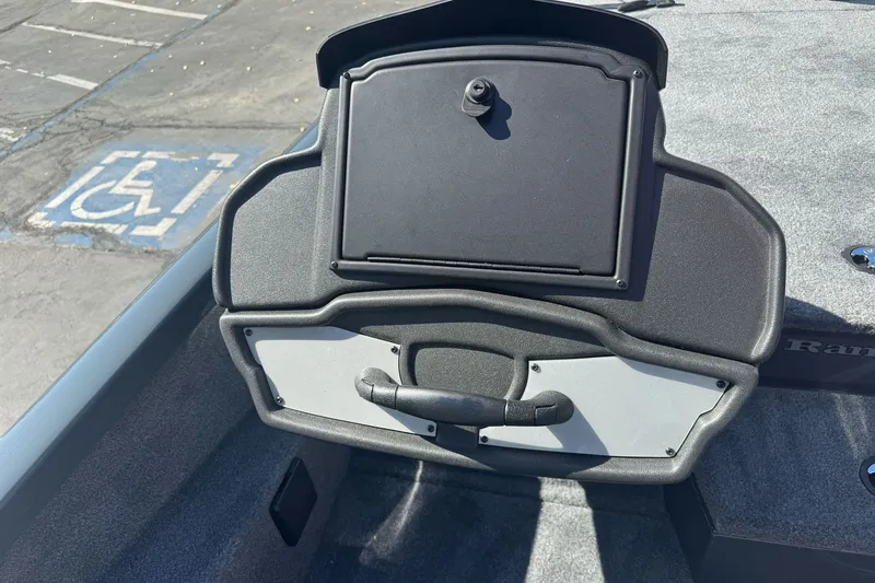 Slide: The Image of 2027 Ranger RT198P boat dashboard with storage compartment, parked in a lot. - 16