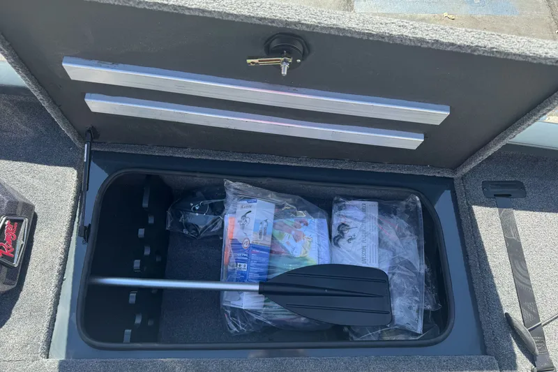 Slide: The Image of Open storage compartment in 2027 Ranger RT198P boat with paddle and gear. - 13