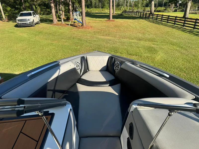 Slide: The Image of The image shows the bow area of a 2018 Tigé R23 boat on a lawn. - 7