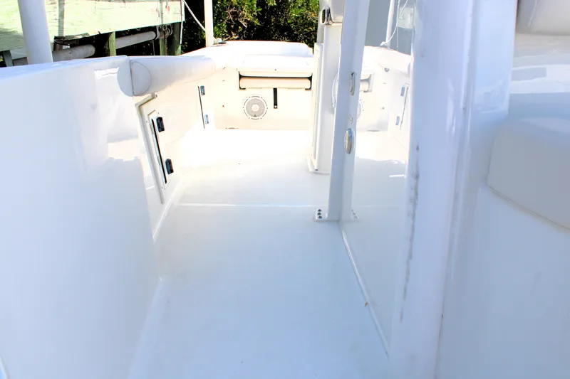 Slide: The Image of 2022 Sea Hunt BX25FS boat interior, featuring sleek white deck and storage compartments. - 18