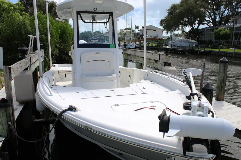 Slide: The Image of 2022 Sea Hunt BX25FS boat docked at a marina, showcasing sleek design and modern features. - 31