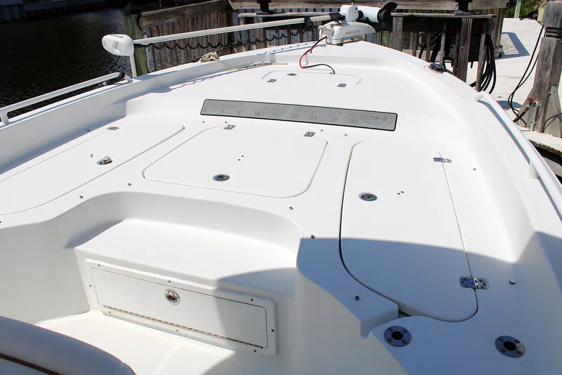 Slide: The Image of 2022 Sea Hunt BX25FS boat deck with storage compartments and railing. - 34