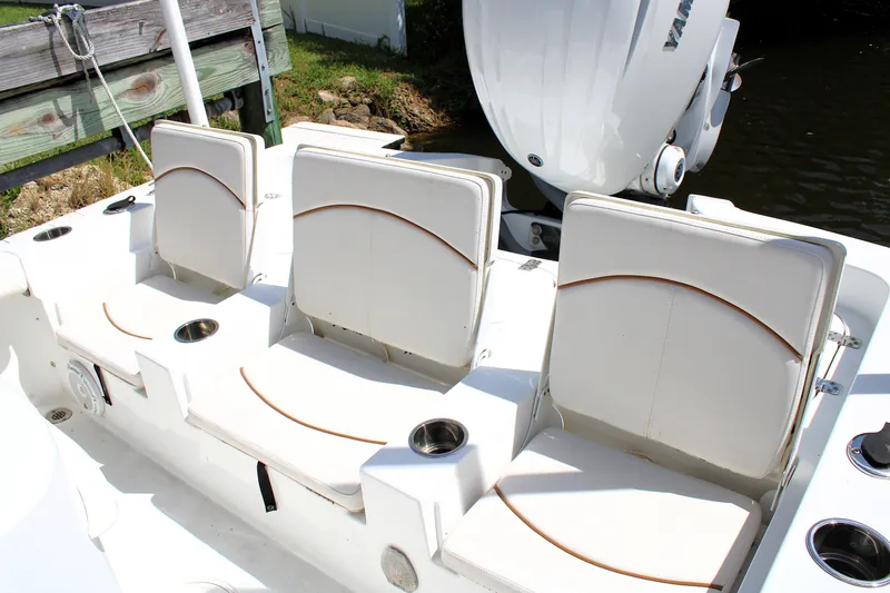 Slide: The Image of 2022 Sea Hunt BX25FS boat with white seating and Yamaha engine. - 10