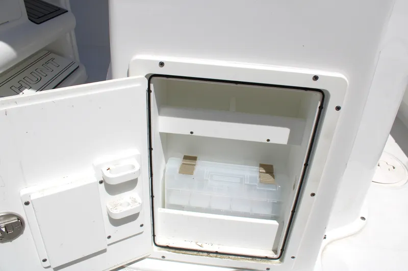 Slide: The Image of Open storage compartment on 2022 Sea Hunt BX25FS boat, featuring organized interior space. - 16