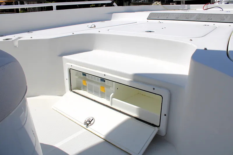 Slide: The Image of 2022 Sea Hunt BX25FS boat storage compartment with open hatch, showcasing interior space. - 35