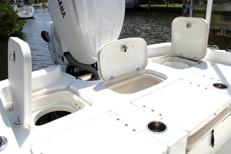Slide: The Image of 2022 Sea Hunt BX25FS boat with open storage compartments and Yamaha engine. - 8
