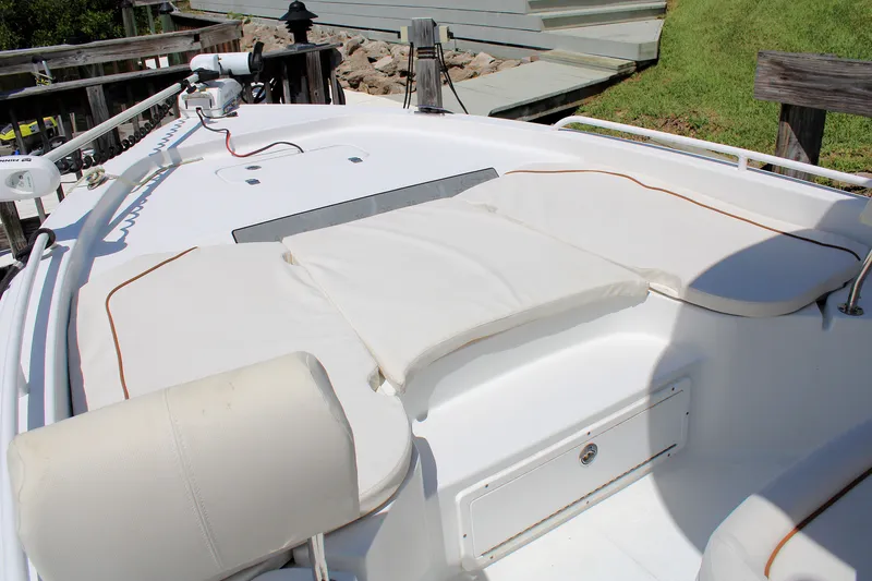 Slide: The Image of 2022 Sea Hunt BX25FS boat with cushioned seating and storage compartment. - 37