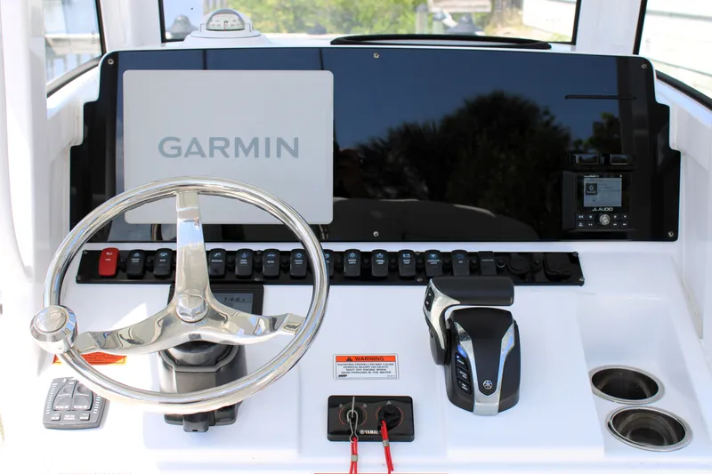 Slide: The Image of 2022 Sea Hunt BX25FS boat dashboard with Garmin navigation and Yamaha controls. - 11