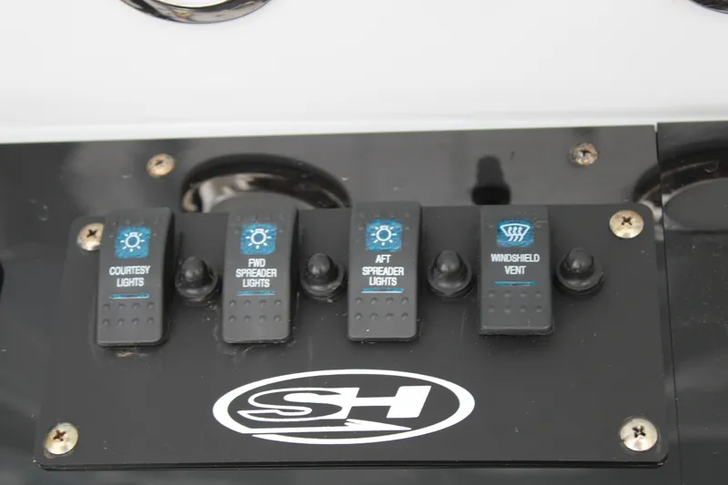 Slide: The Image of Control panel of a 2022 Sea Hunt BX25FS boat with light switches. - 26