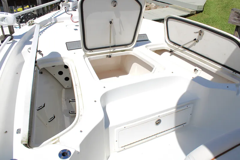 Slide: The Image of 2022 Sea Hunt BX25FS boat with open storage compartments on deck. - 36