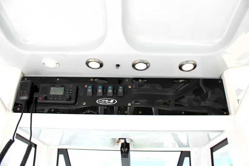 Slide: The Image of 2022 Sea Hunt BX25FS boat console with Garmin radio and control switches. - 28
