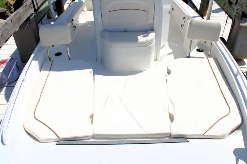 Slide: The Image of 2022 Sea Hunt BX25FS boat interior with cushioned seating and storage compartments. - 38