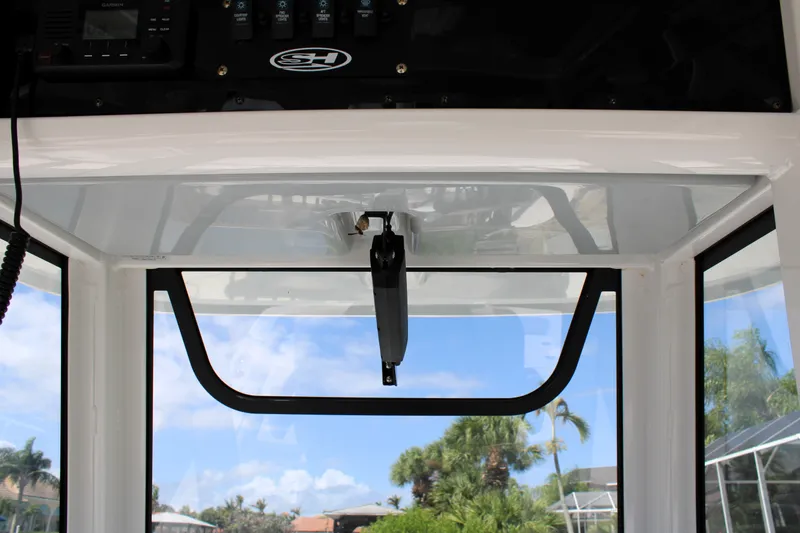Slide: The Image of 2022 Sea Hunt BX25FS boat windshield and console with clear sky view. - 29