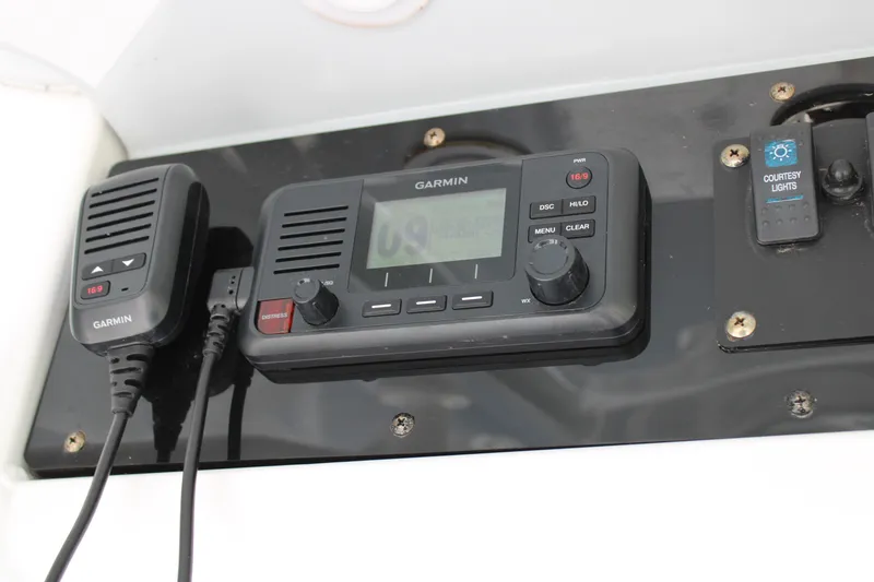 Slide: The Image of Garmin marine radio and controls on 2022 Sea Hunt BX25FS boat dashboard. - 27