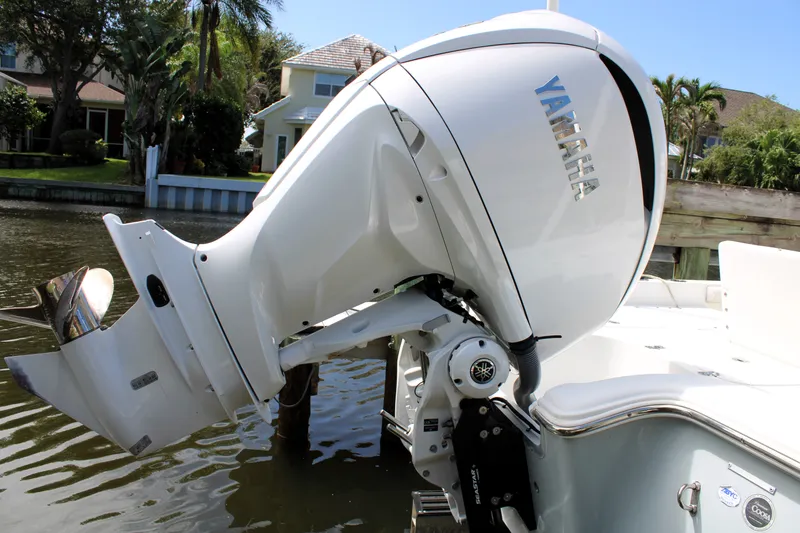 Slide: The Image of 2022 Sea Hunt BX25FS boat with Yamaha outboard motor in a scenic waterfront setting. - 6