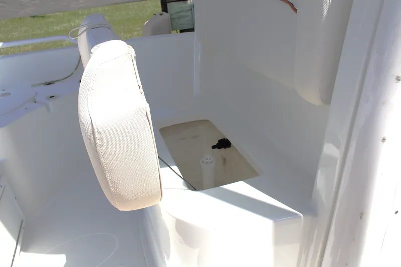 Slide: The Image of 2022 Sea Hunt BX25FS boat interior with white seating and storage compartment. - 33